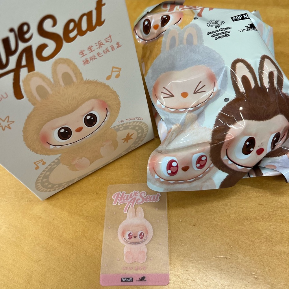The Monsters Labubu Have a Seat pink “Dada” plush pendant blind box